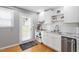 Modern kitchen featuring white cabinets, stainless steel appliances and a door to the backyard at 2706 Mcneil St St, Raleigh, NC 27608
