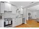 Open kitchen with stainless steel appliances, white cabinetry and views into the living area at 2706 Mcneil St St, Raleigh, NC 27608