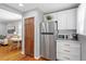 Efficient kitchen featuring stainless steel refrigerator, white cabinets and hardwood floors at 2706 Mcneil St St, Raleigh, NC 27608