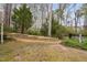 Backyard showcasing a retaining wall and lush greenery at 3108 Bluff Oak Dr, Cary, NC 27519