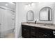 Bathroom features a double sink vanity with granite countertops and tub with shower at 3108 Bluff Oak Dr, Cary, NC 27519