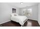 Bright bedroom features a comfortable bed, hardwood floors, and a sunny window at 3108 Bluff Oak Dr, Cary, NC 27519