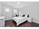 Cozy bedroom features a bright sunny window, hardwood floors, and comfortable modern decor at 3108 Bluff Oak Dr, Cary, NC 27519