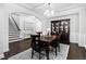 Formal dining room with coffered ceiling, modern chandelier and dark wood furniture at 3108 Bluff Oak Dr, Cary, NC 27519