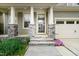 Inviting front porch with stone accents and decorative pillars, leading to the front door at 3108 Bluff Oak Dr, Cary, NC 27519
