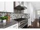 Modern kitchen features stainless steel appliances, granite counters, and mosaic tile backsplash at 3108 Bluff Oak Dr, Cary, NC 27519