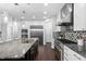 Gourmet kitchen with granite countertops, stainless steel appliances, and mosaic backsplash at 3108 Bluff Oak Dr, Cary, NC 27519