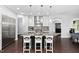 Modern kitchen featuring a large island, stainless steel appliances, and stylish pendant lighting at 3108 Bluff Oak Dr, Cary, NC 27519