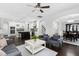 Open-concept living room flows into kitchen with dark wood floors and modern furnishings at 3108 Bluff Oak Dr, Cary, NC 27519