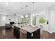 Open-concept living area boasts natural light, fireplace, and kitchen island with granite countertop at 3108 Bluff Oak Dr, Cary, NC 27519