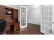 Bright office features a dark wood desk, hardwood floors and french doors to another room at 3108 Bluff Oak Dr, Cary, NC 27519