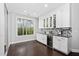 Entertain guests with a wine fridge, custom cabinets, granite countertops and built in shelving at 3108 Bluff Oak Dr, Cary, NC 27519