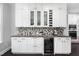 Entertain guests with a wine fridge, custom cabinets, granite countertops and built in shelving at 3108 Bluff Oak Dr, Cary, NC 27519