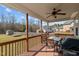 Inviting back deck with an outdoor dining set and grill, perfect for enjoying the backyard view at 36 Deep Woods Ln, Cameron, NC 28326