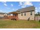 Rear exterior view of the home featuring a wood deck, a spacious yard, and a neutral siding at 36 Deep Woods Ln, Cameron, NC 28326