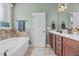 Relaxing bathroom featuring a soaking tub, double vanity, and natural light at 36 Deep Woods Ln, Cameron, NC 28326