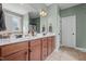 Bathroom featuring double sinks, granite counters, and decorative lighting at 36 Deep Woods Ln, Cameron, NC 28326