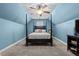 Cozy bedroom featuring light blue walls, carpet flooring, and a four poster bed with stylish bedding at 36 Deep Woods Ln, Cameron, NC 28326