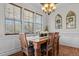 Charming dining room boasts a rustic wooden table, natural light, and decorative mirrors at 36 Deep Woods Ln, Cameron, NC 28326