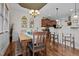 Charming dining area featuring a rustic table, hardwood floors, and access to the kitchen at 36 Deep Woods Ln, Cameron, NC 28326