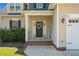Close-up of a charming front entryway with a welcoming wreath and decorative welcome sign at 36 Deep Woods Ln, Cameron, NC 28326