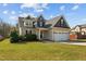 Beautiful two-story home with a well-manicured lawn, and convenient two-car garage at 36 Deep Woods Ln, Cameron, NC 28326