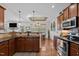 Well-designed kitchen features wood cabinets, sleek countertops, and stainless steel appliances at 36 Deep Woods Ln, Cameron, NC 28326