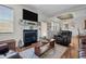 Inviting living room showcasing a fireplace, large TV, and open access to the dining area at 36 Deep Woods Ln, Cameron, NC 28326