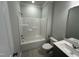 Bathroom with white tub, toilet and vanity with stainless steel faucet and hardware at 4012 Shadbush St, Raleigh, NC 27616