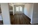 Dining room with hardwood floors, modern light fixture, and a view to the backyard at 4012 Shadbush St, Raleigh, NC 27616