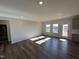 Spacious living room with hardwood flooring, windows for natural light, and access to the backyard at 4012 Shadbush St, Raleigh, NC 27616