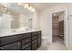 Bathroom boasts double sink vanity, framed mirror, and access to the walk-in closet at 4220 Congleton Pl, Durham, NC 27703