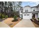 Inviting two-story home featuring gray siding, a one-car garage, and a well-maintained front lawn with shrubbery at 4220 Congleton Pl, Durham, NC 27703