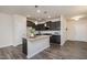 Charming kitchen with gray cabinets, granite countertops, and stainless steel microwave at 4220 Congleton Pl, Durham, NC 27703
