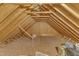 Unfinished attic space showing exposed rafters and wooden beams, suitable for storage or expansion at 4516 Ocean Crest Cir, Raleigh, NC 27603