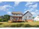 Two-story home with large backyard, deck with patio furniture, and mature trees at 4516 Ocean Crest Cir, Raleigh, NC 27603