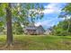 The vast backyard stretches out from the house, featuring a mix of lush greenery and mature trees, offering space for recreation at 4516 Ocean Crest Cir, Raleigh, NC 27603