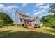 Spacious backyard featuring a multi-level wooden deck and blue siding on a two-story home at 4516 Ocean Crest Cir, Raleigh, NC 27603
