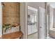 Bright bathroom featuring a tub, natural wood accent wall, and storage at 4516 Ocean Crest Cir, Raleigh, NC 27603