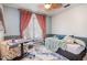 A cozy bedroom featuring a ceiling fan, large window, and blue accent wall at 4516 Ocean Crest Cir, Raleigh, NC 27603
