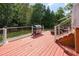 An outdoor deck with railings and stairs, including a large grill at 4516 Ocean Crest Cir, Raleigh, NC 27603