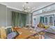 Dining room with large table, decorative lighting, and green curtains at 4516 Ocean Crest Cir, Raleigh, NC 27603