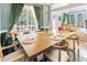 Elegant dining area featuring a long wooden table, seating with views of the exterior at 4516 Ocean Crest Cir, Raleigh, NC 27603