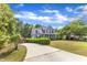 Long driveway leads up to a charming two-story home with a inviting front porch at 4516 Ocean Crest Cir, Raleigh, NC 27603