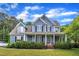 Charming two-story home featuring a welcoming front porch and beautifully manicured landscaping at 4516 Ocean Crest Cir, Raleigh, NC 27603