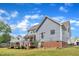 Rear view of home with light-blue siding, deck, patio and yard space at 4516 Ocean Crest Cir, Raleigh, NC 27603