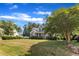 Landscaped front yard featuring a two-story home with a charming front porch beneath blue skies at 4516 Ocean Crest Cir, Raleigh, NC 27603