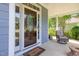 Charming stained-glass front door entrance with covered porch and seating at 4516 Ocean Crest Cir, Raleigh, NC 27603