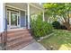 Close-up of front door and brick steps leading to inviting front porch with white pillars at 4516 Ocean Crest Cir, Raleigh, NC 27603