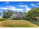 Expansive front lawn showcases a blue two-story home with inviting front porch and lush greenery at 4516 Ocean Crest Cir, Raleigh, NC 27603